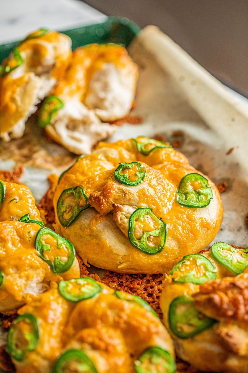 jalapeno cheese pretzels on parchment lined baking sheet