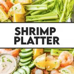 shrimp platter with celery, cucumbers, lemon wedges, cajun aioli and cocktail sauce