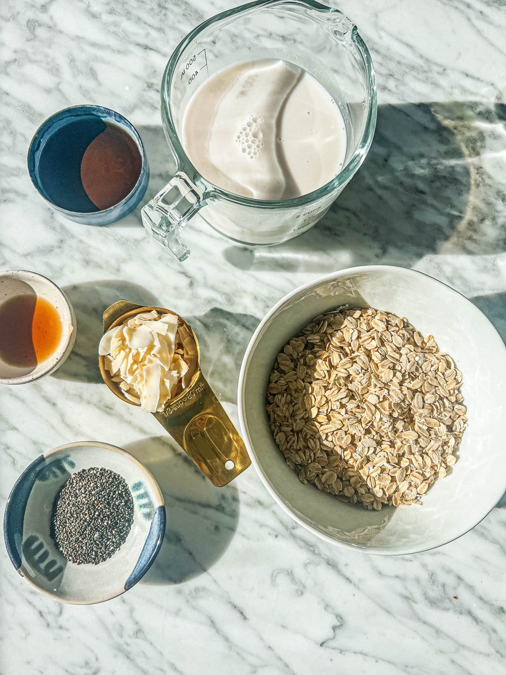 coconut milk, chia seeds, maple syrup, vanilla extract, coconut flakes, rolled oats