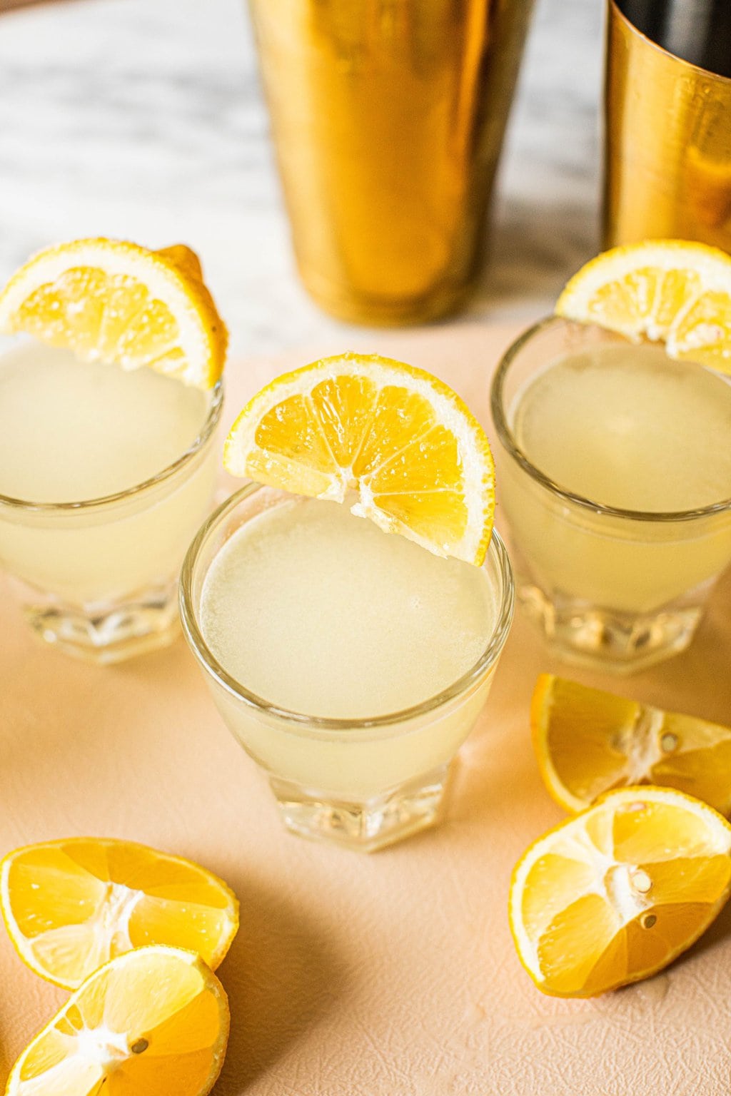 lemon drop shot with lemon wedges on cutting board