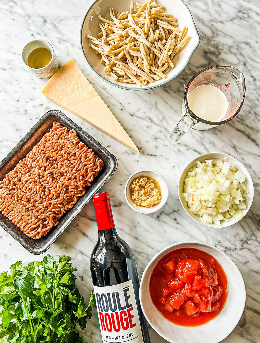 pasta, parmesan cheese, sausage, heavy cream, onions, garlic, diced tomatoes, red wine, basil