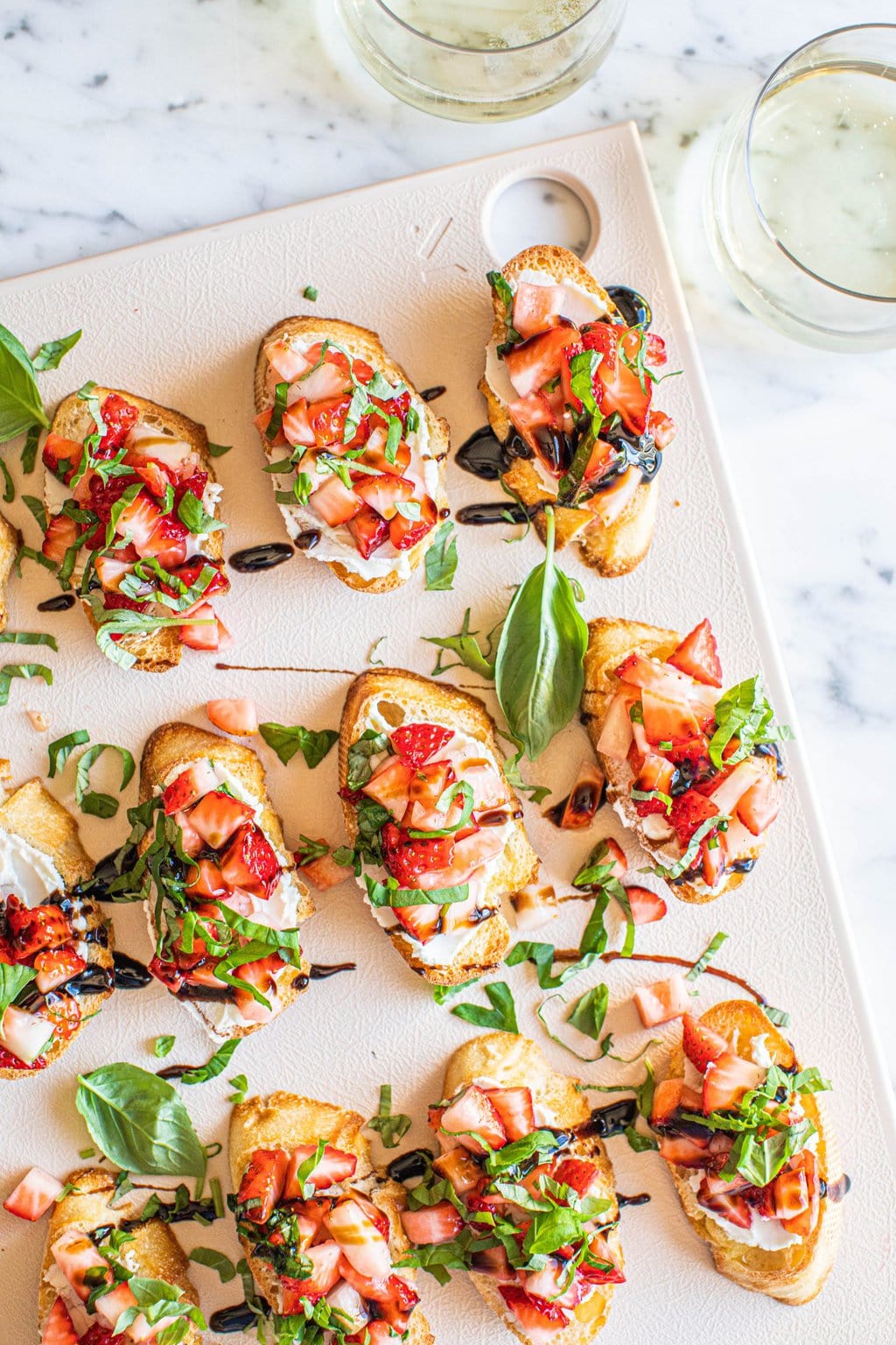 goat cheese strawberry bruschetta on white platter