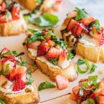 strawberry goat cheese bruschetta on white platter