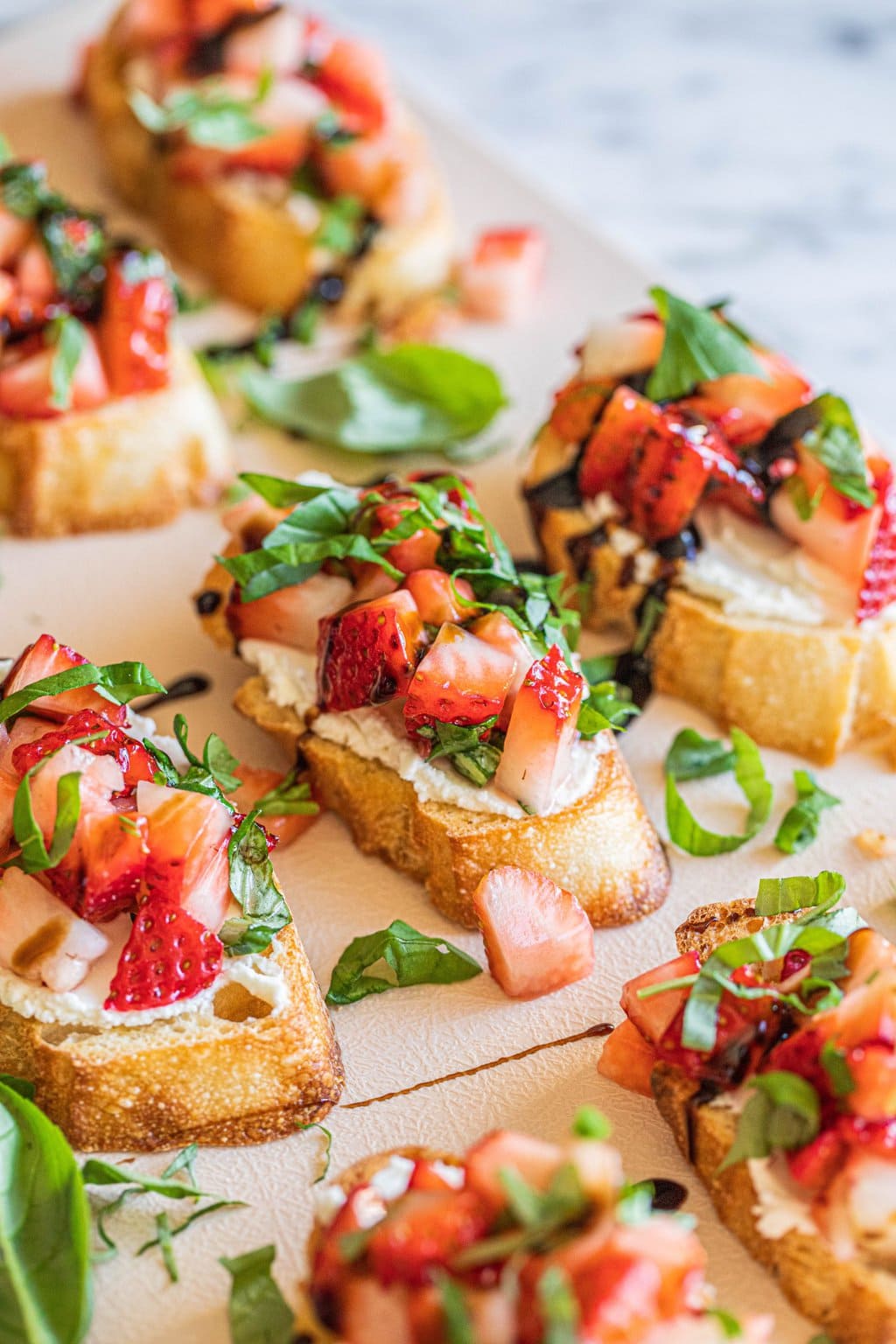 strawberry goat cheese bruschetta on white platter