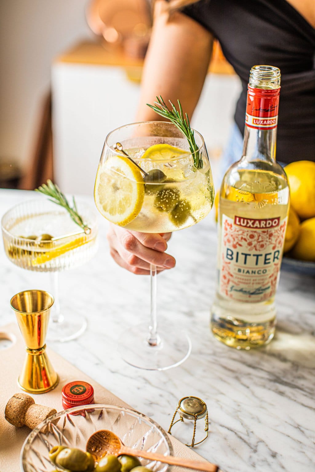 woman holding white spritz bianco in wine glass