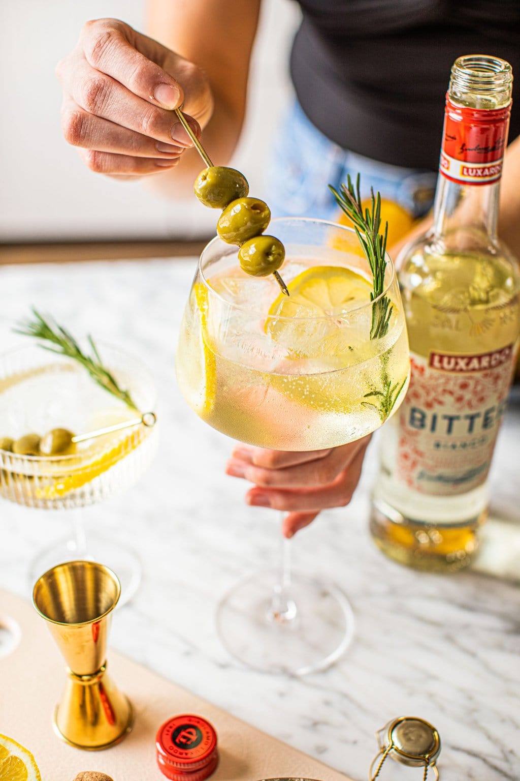 woman holding bianco spritz in wine glass