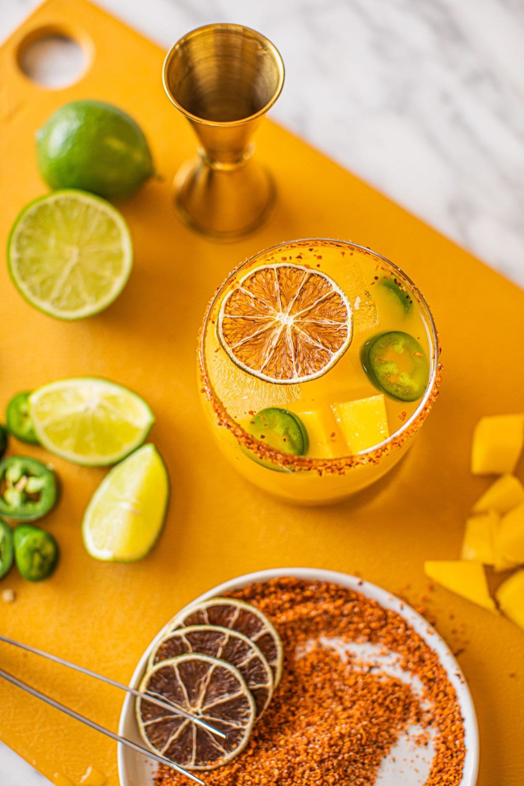 jalapeno mango margarita in low ball glass with tajin