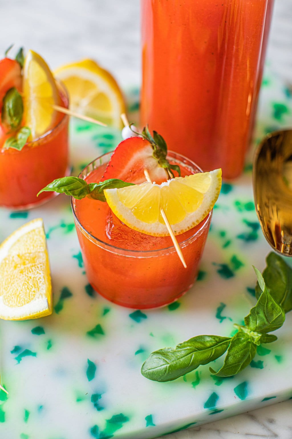 strawberry basil lemonade garnished with strawberry and fresh lemon wedge