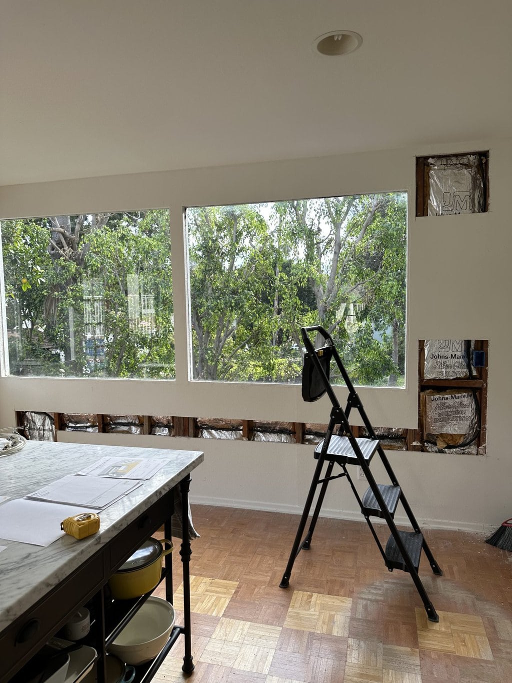 a pool house with two large windows and open patch work