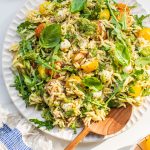 a serving of orzo salad with arugula, tomatoes, and mozarella