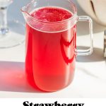 strawberry simple syrup in a glass pitcher