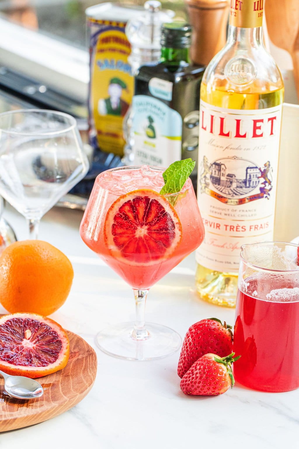 blood orange strawberry spritz garnished with a slice of orange