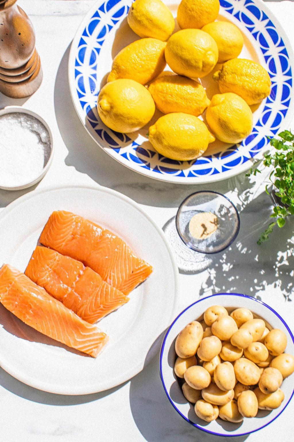 lemons, potatoes, salmon, olive oil, salt, pepper, and oregano