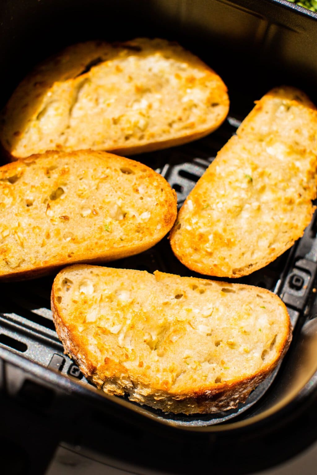 browned and crispy garlic bread in the air fryer basket