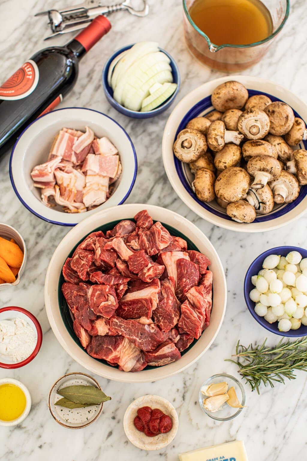 beef, bacon, mushrooms, onion, bay leaf, pearl onions, garlic, red wine, beef stock, butter, carrots, flour, and more to make beef bourguignon 