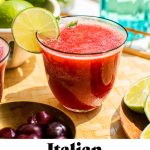 a cherry italian margarita with a lime wedge and text overlay