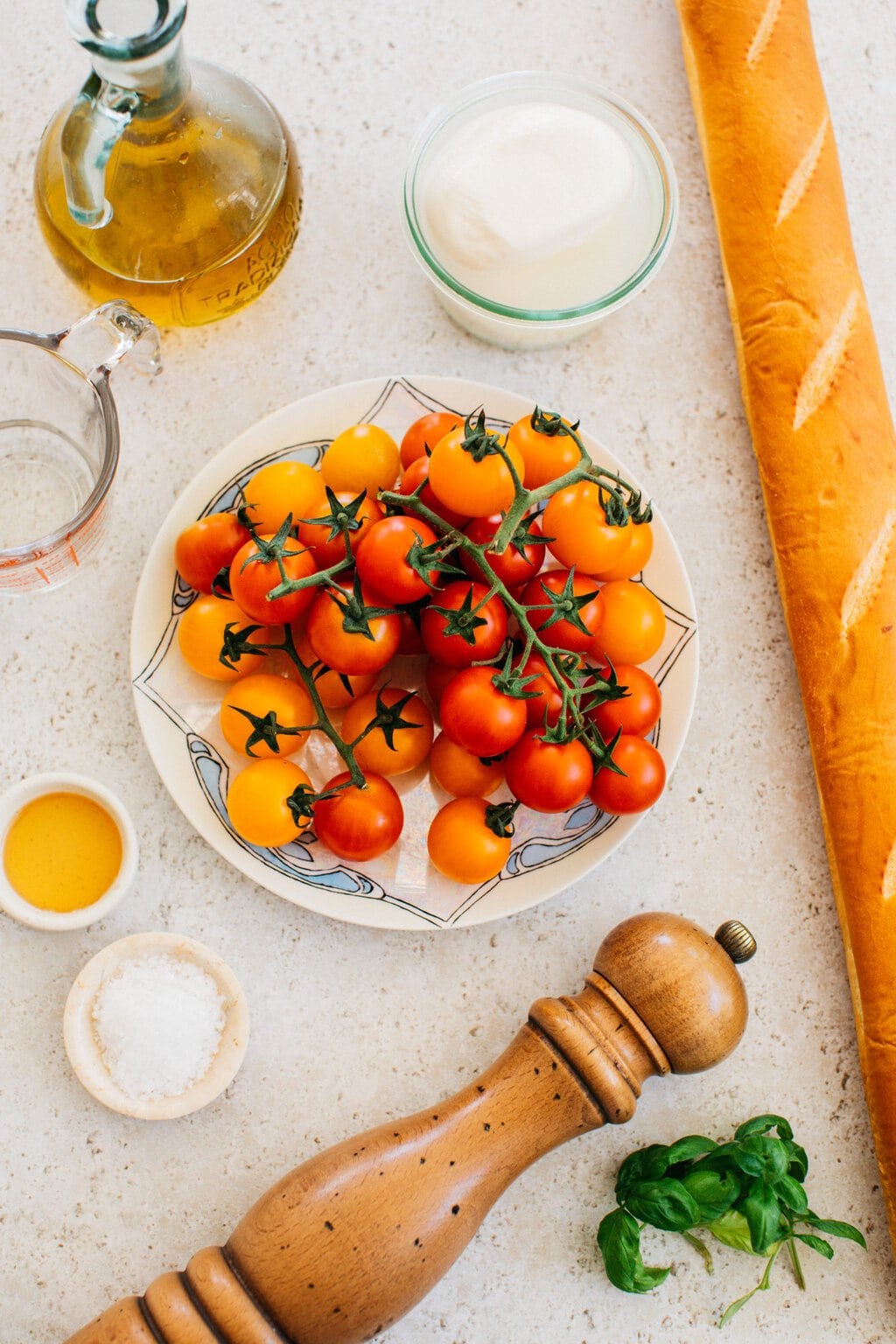 cherry tomatoes, black pepper, salt, white wine vinegar, burrata, and a baguette