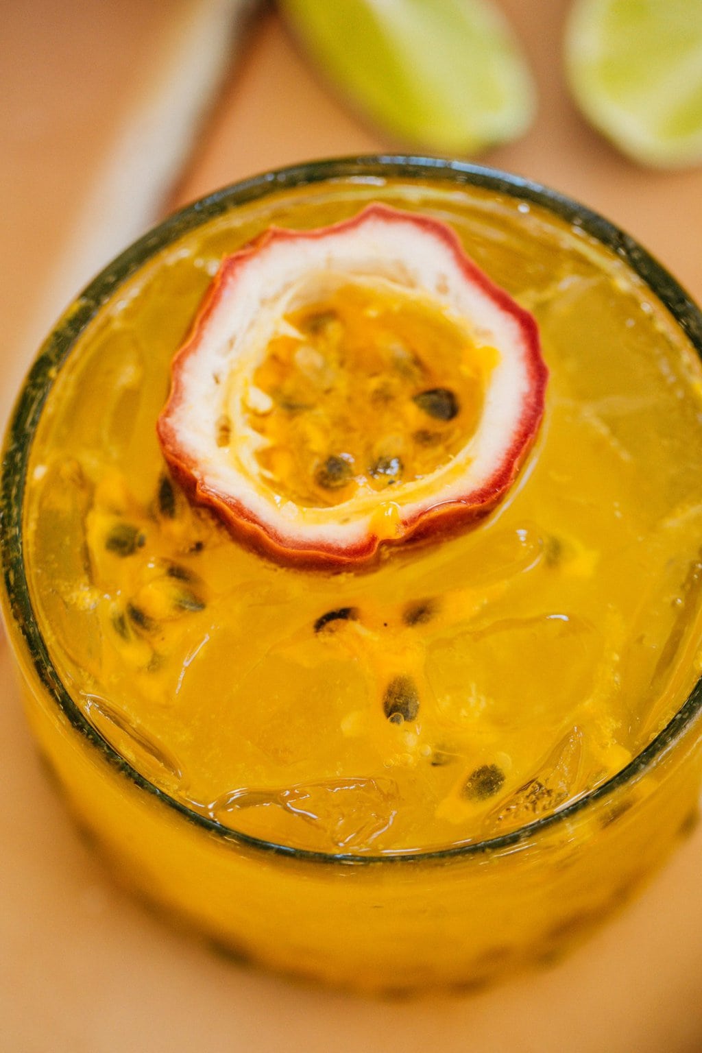 closeup overhead shot of passion fruit spritz with a slice of passion fruit in the glass