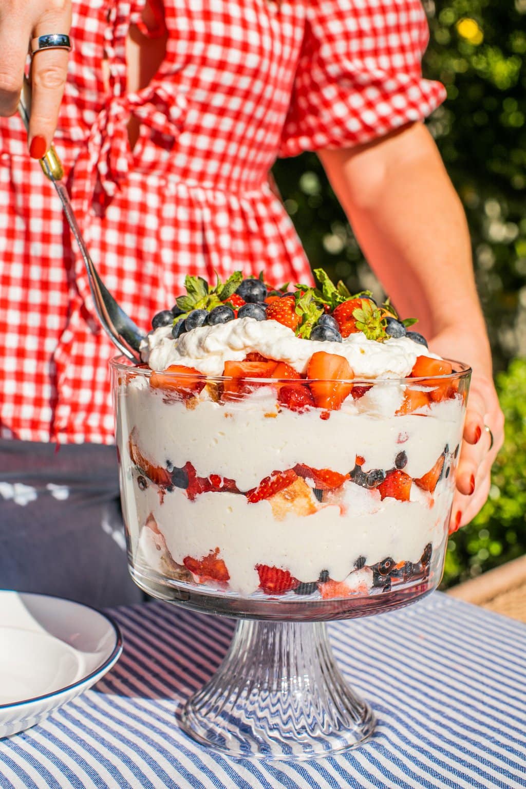 Elizabeth digging into the berry trifle with a large spoon