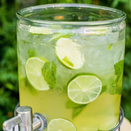 a hugo spritz served in a large pitcher with a self serve spout