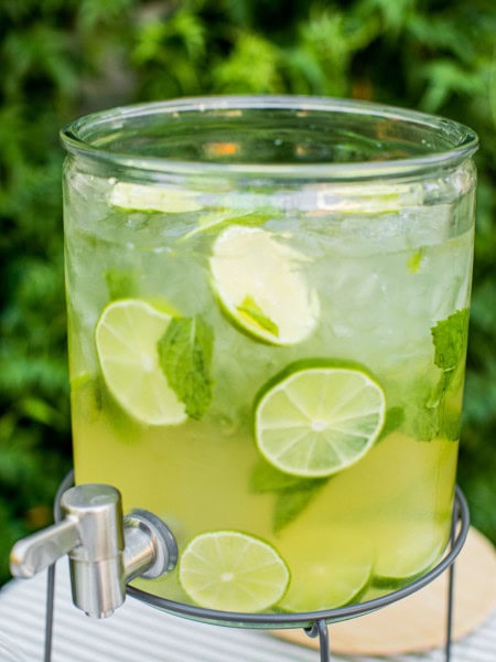 a hugo spritz served in a large pitcher with a self serve spout