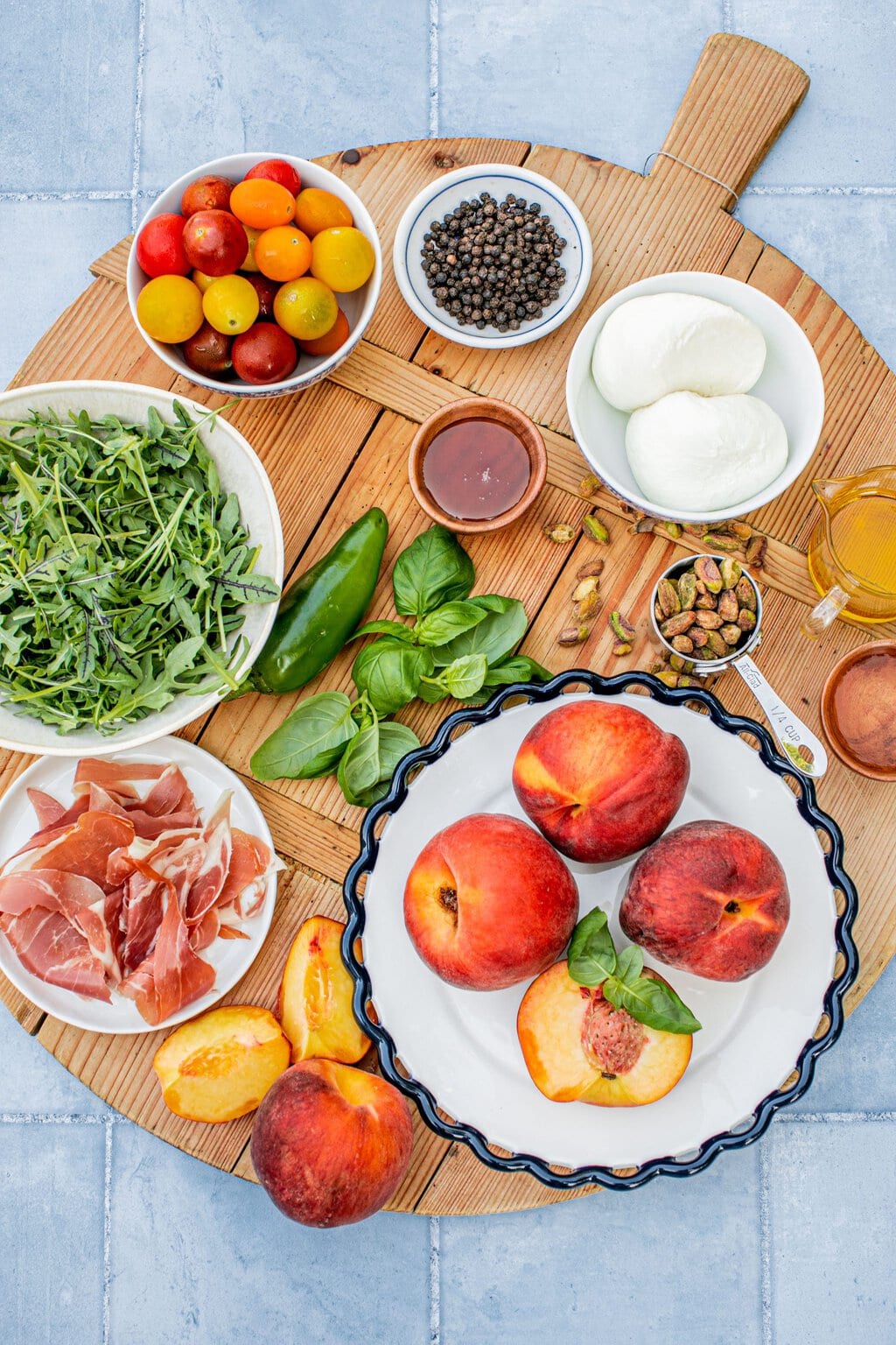 peaches, proscuitto, pistachio, basil, vinegar, burrata, arugula, and honey to make salad