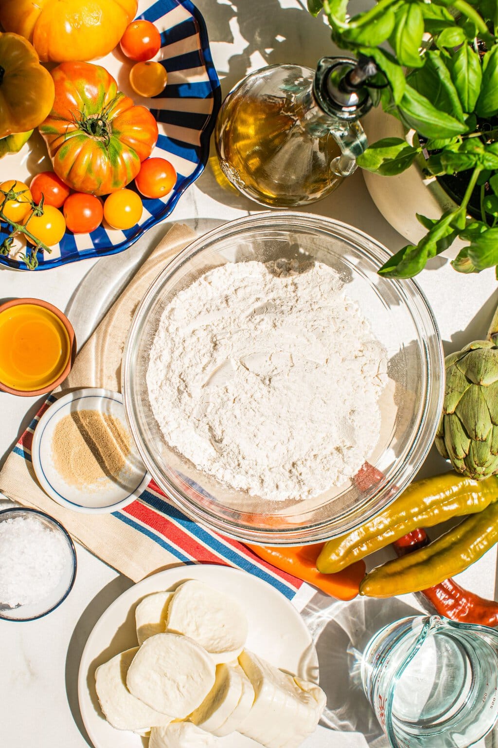 flour, yeast, water, honey, salt, tomatoes, basil, and mozarella