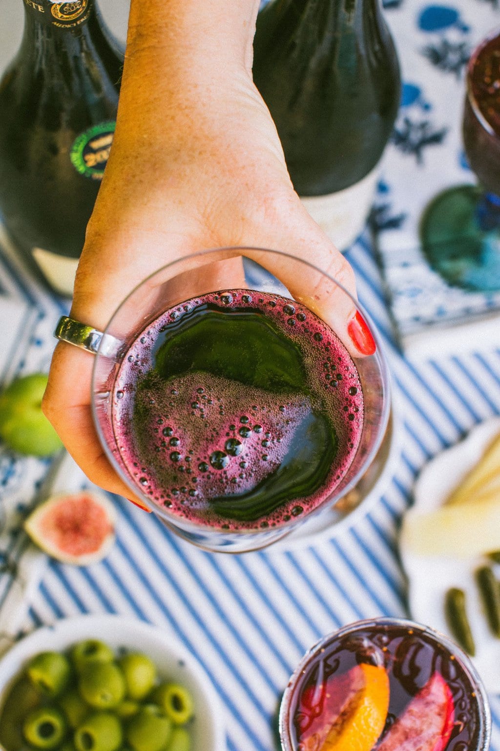 an overhead shot of elizabeth holding a glass full of lambrusco 