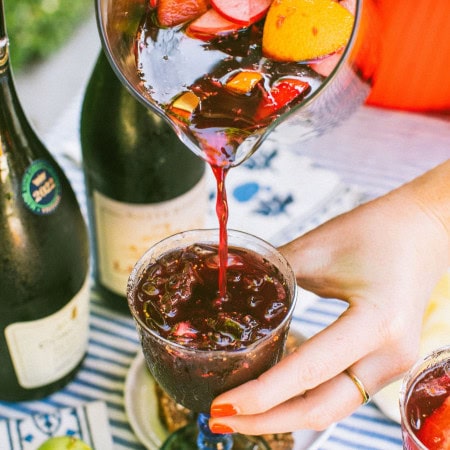 pouring lambrusco sangria into a glass