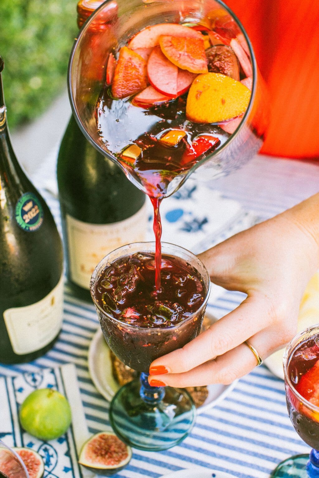 pouring lambrusco sangria into a glass