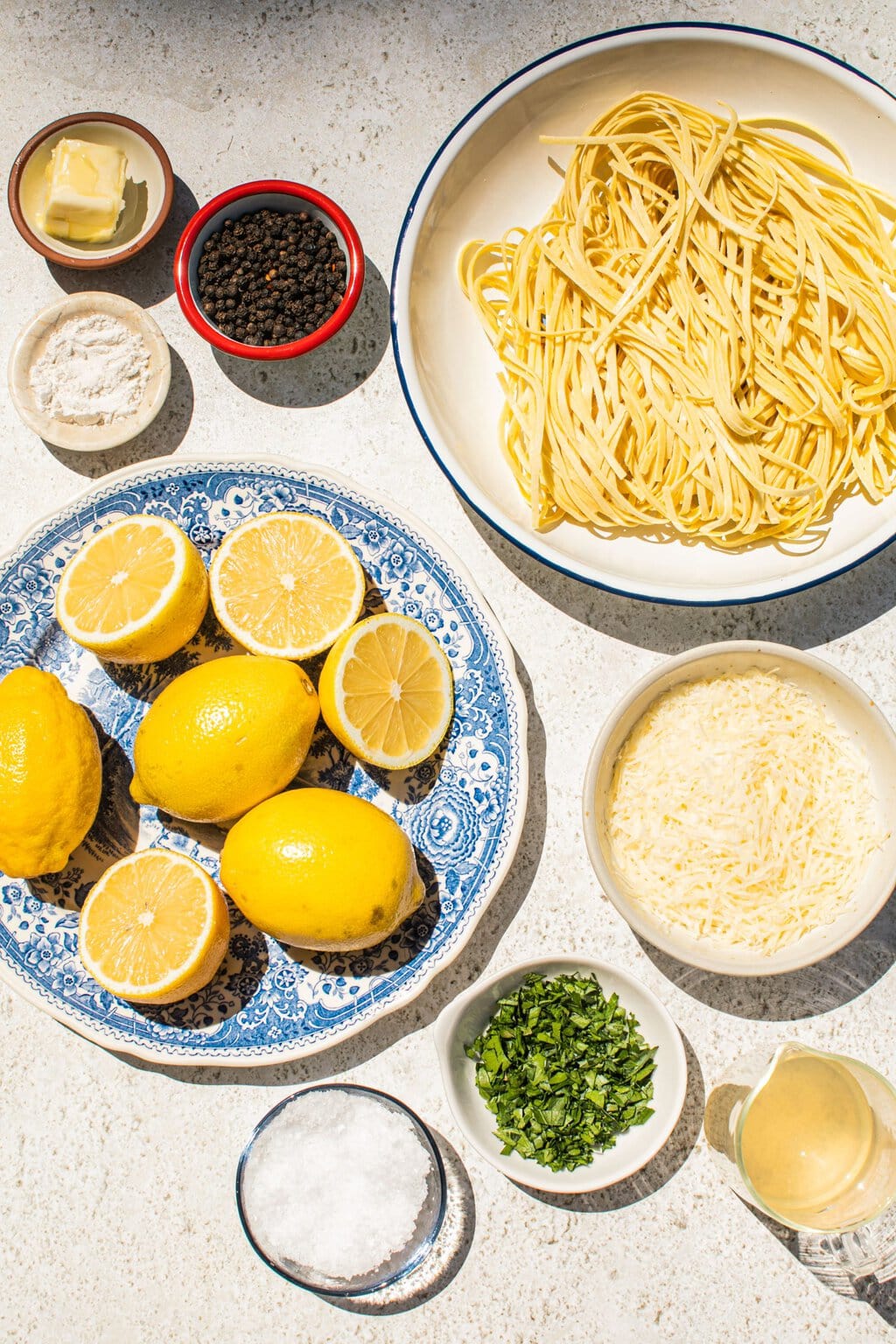 parmesan, lemons, lemon juice, salt, pasta, black pepper, chicken broth, zest, heavy whipping cream, and flour