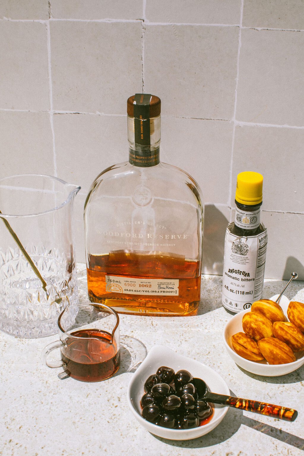 maple syrup, whiskey, bitters, donut holes, and maraschino cherries