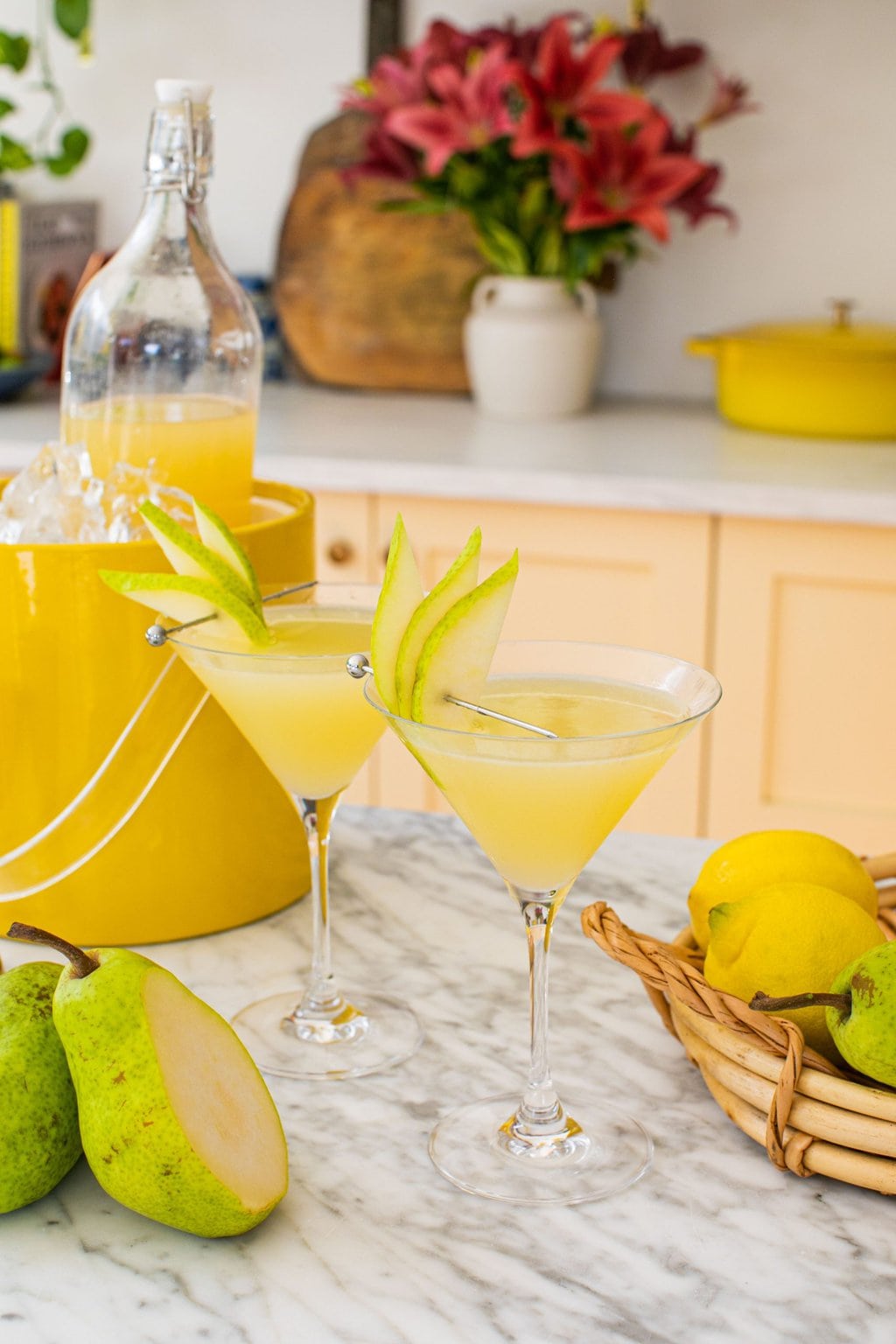 two martini glasses with pear slices as garnish 