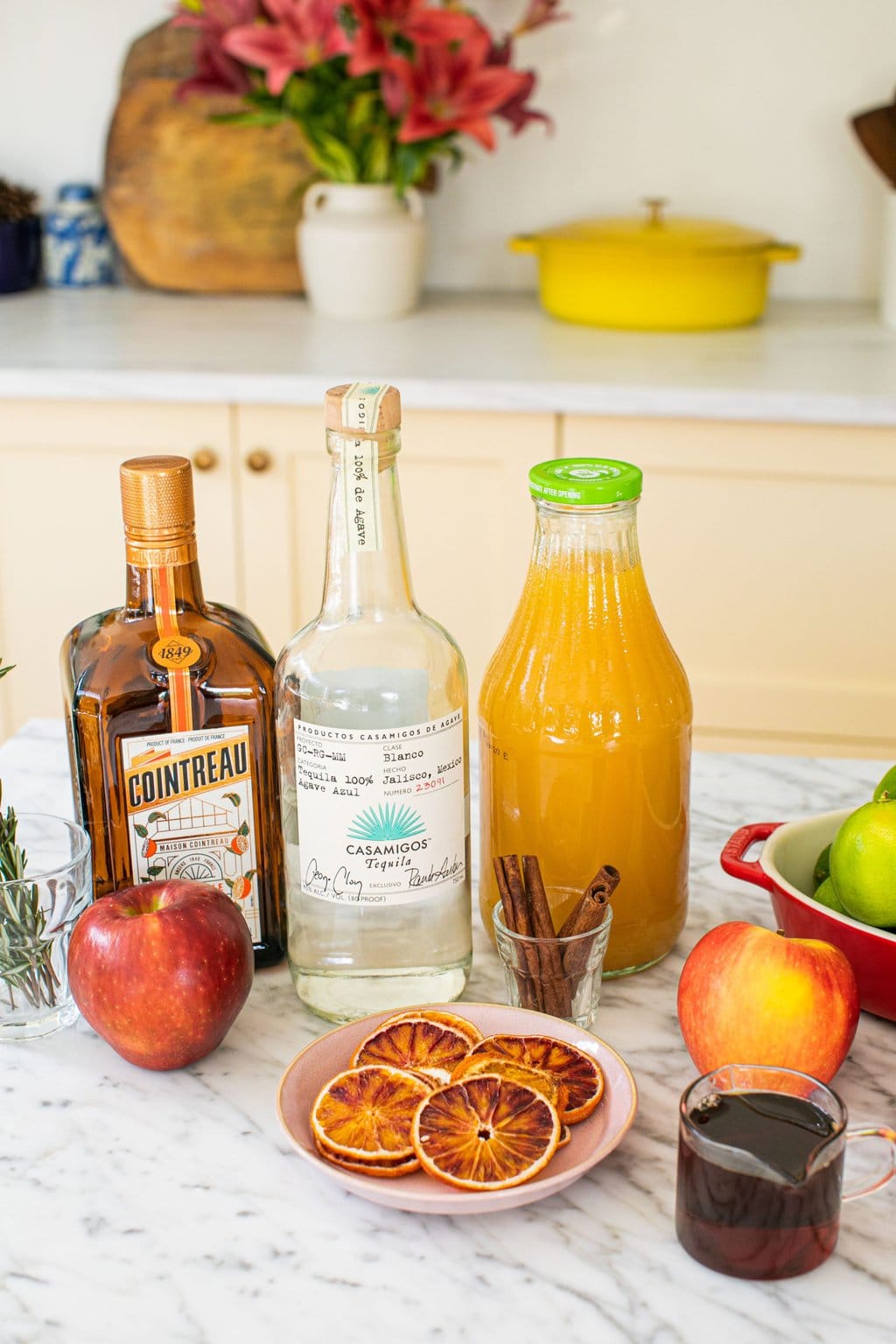 apple cider, casamigos tequila, apples, dried orange slices, maple syrup, cinnamon sticks, rosemary sprigs, and cointreau