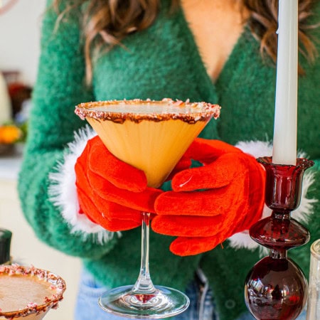 elizabeth wearing red christmas gloves and holding a peppermint espresso martini