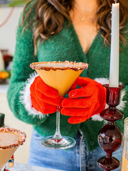 elizabeth wearing red christmas gloves and holding a peppermint espresso martini