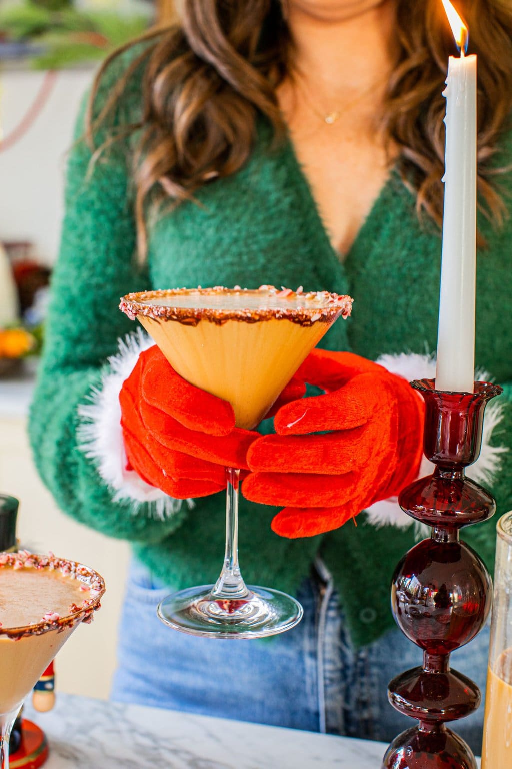 elizabeth wearing red christmas gloves and holding a peppermint espresso martini