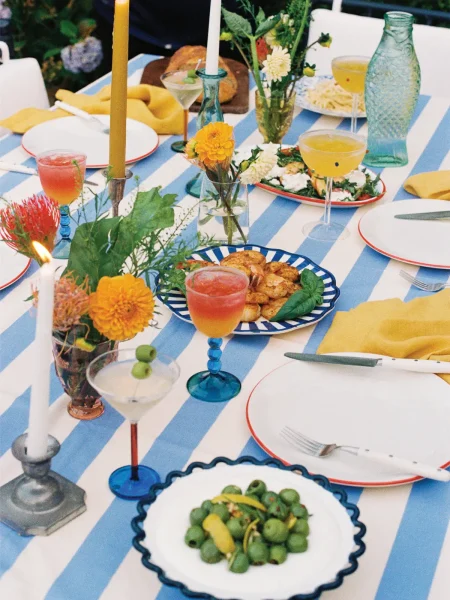 Outdoor table with food and drinks for entertaining.