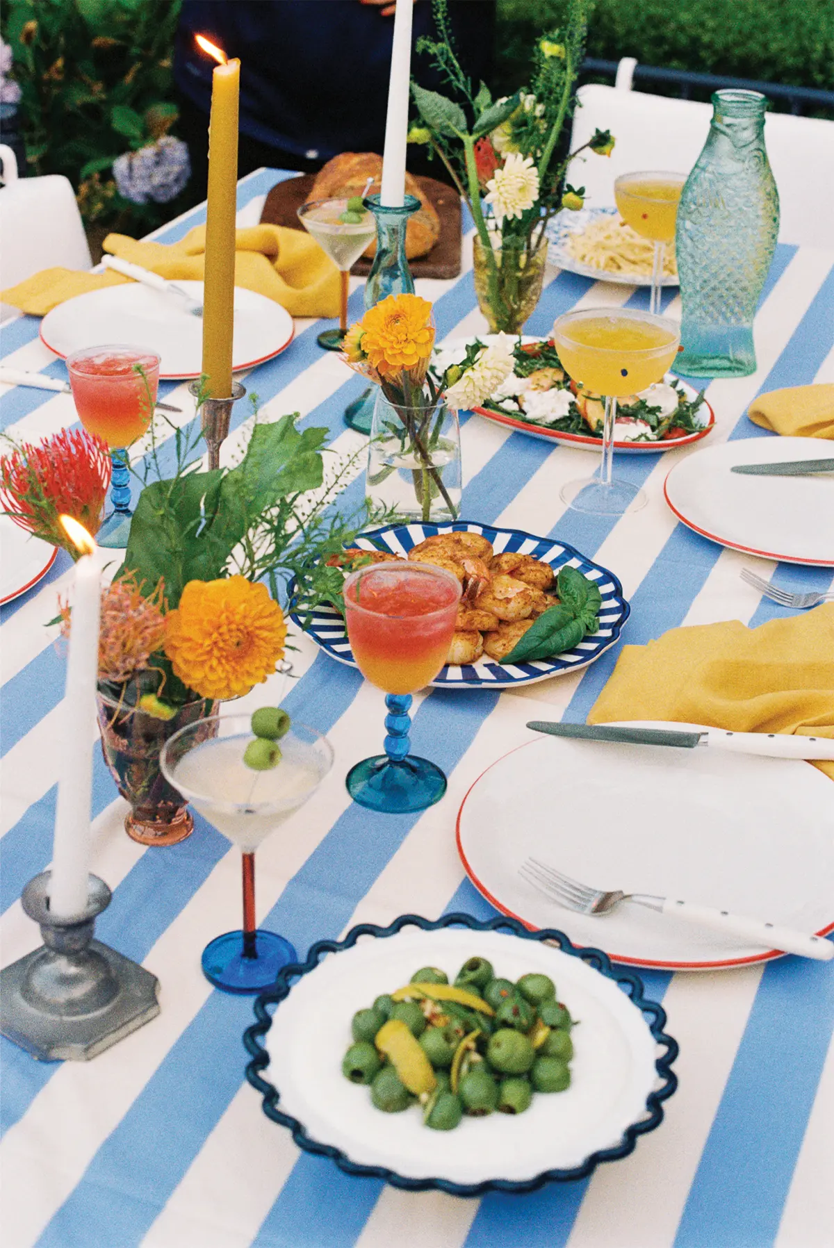 Outdoor table with food and drinks for entertaining.
