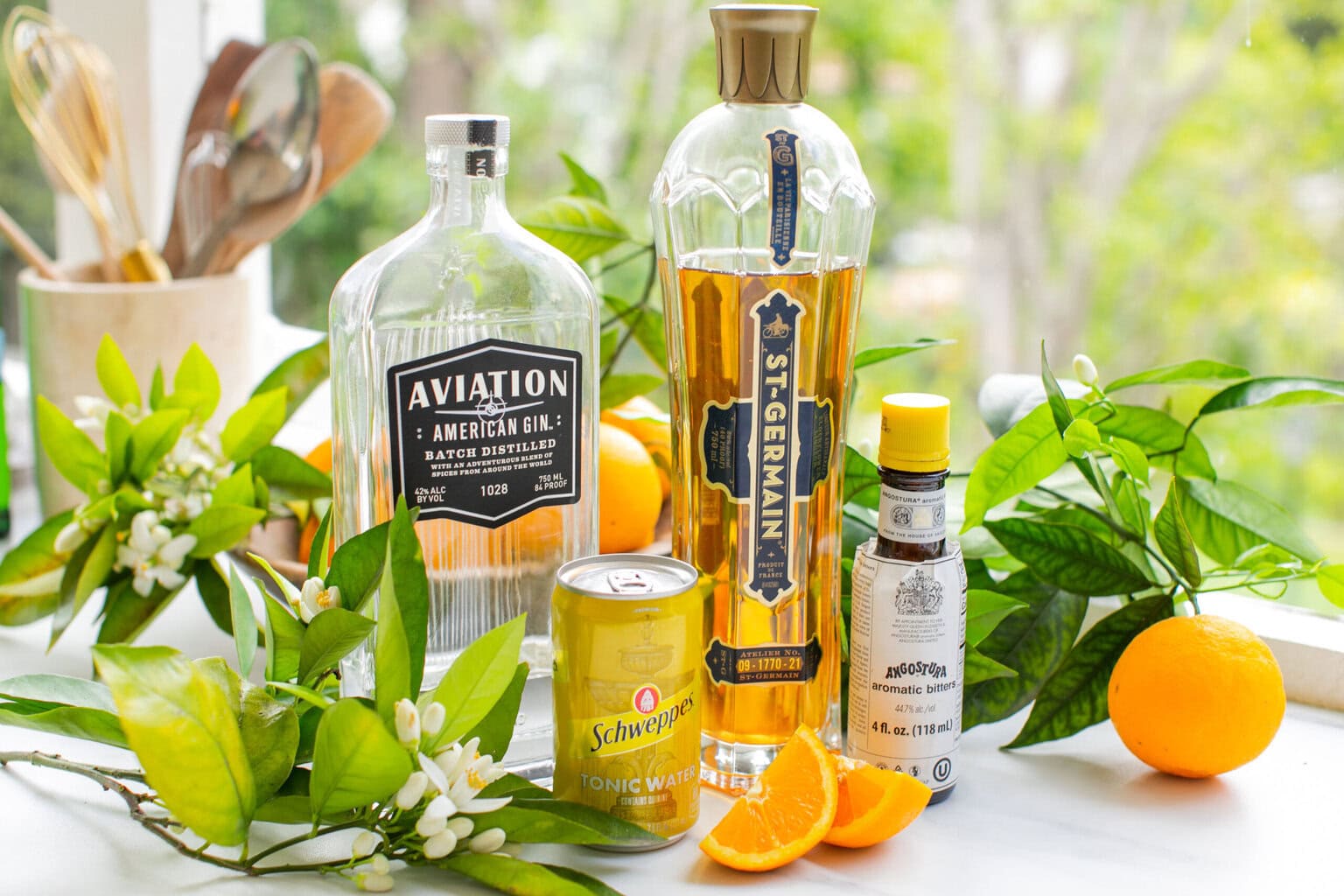gin, elderflower liqueur, oranges, schweppes tonic water, and orange blossoms