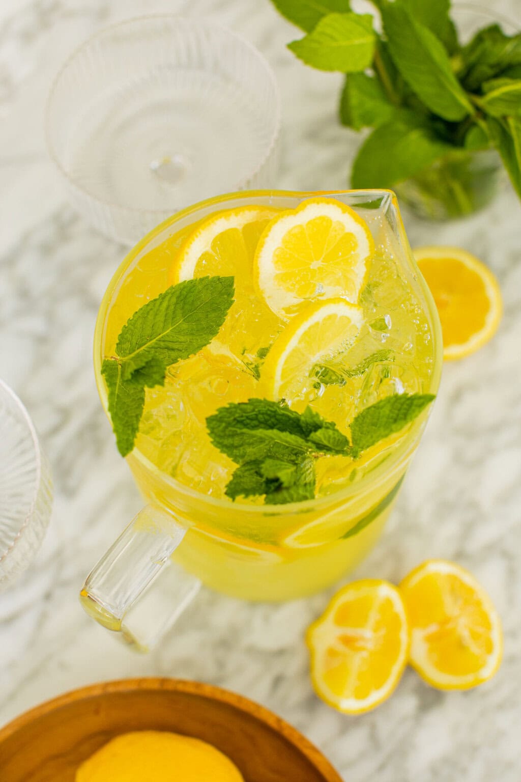 an overhead photo of the pitcher of limoncello spritz with mint leaves and lemons