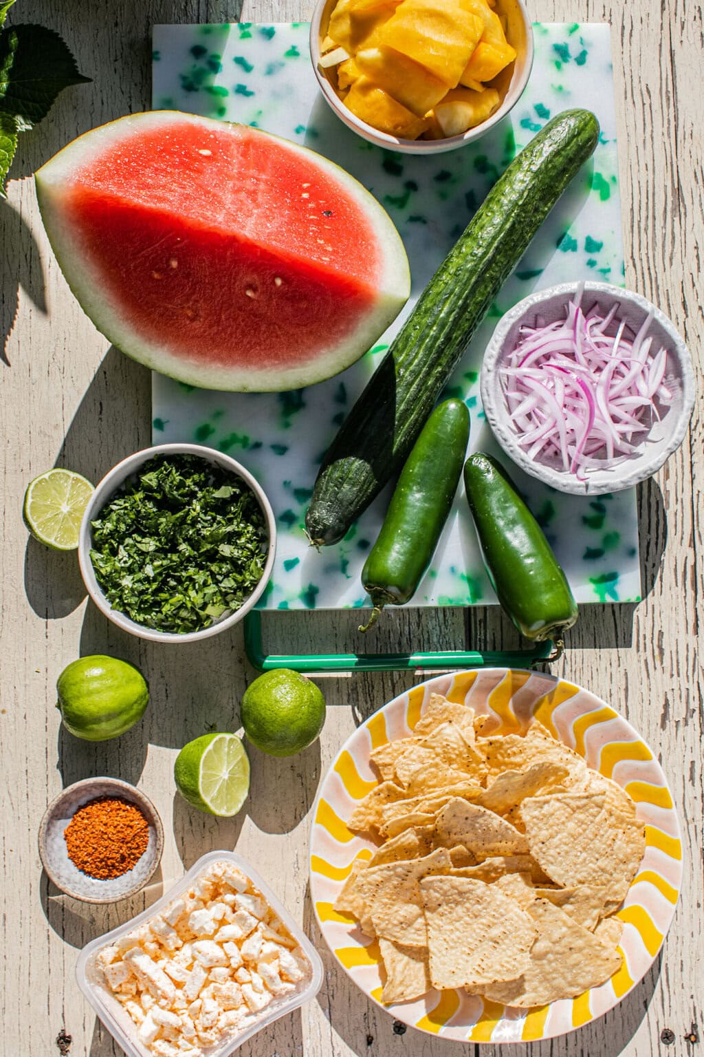 cucumber, watermelon, mango, jalapeno, onion, chips, and limes