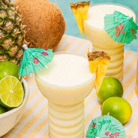 a pina colada mocktail in a fun cup with a mini umbrella in it