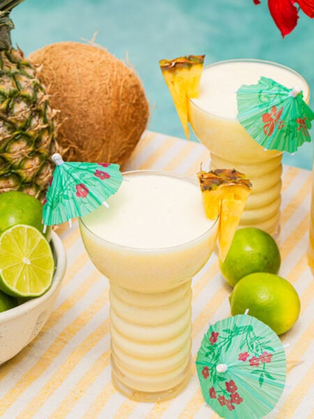a pina colada mocktail in a fun cup with a mini umbrella in it