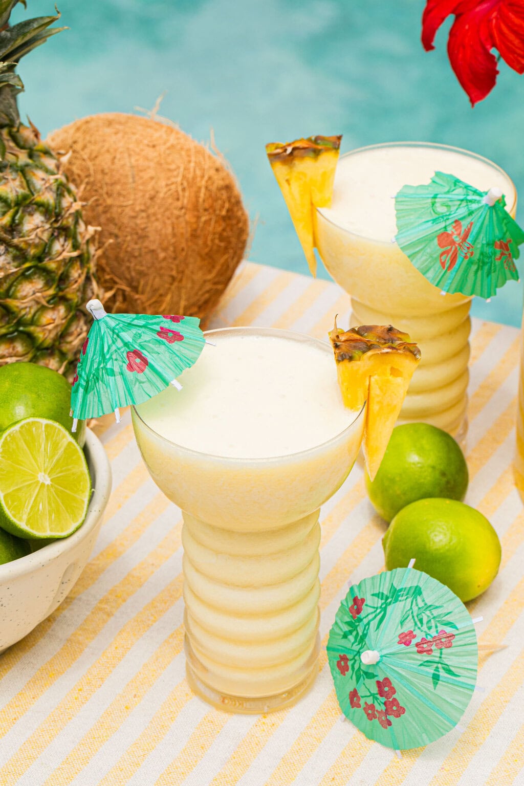 a pina colada mocktail in a fun cup with a mini umbrella in it