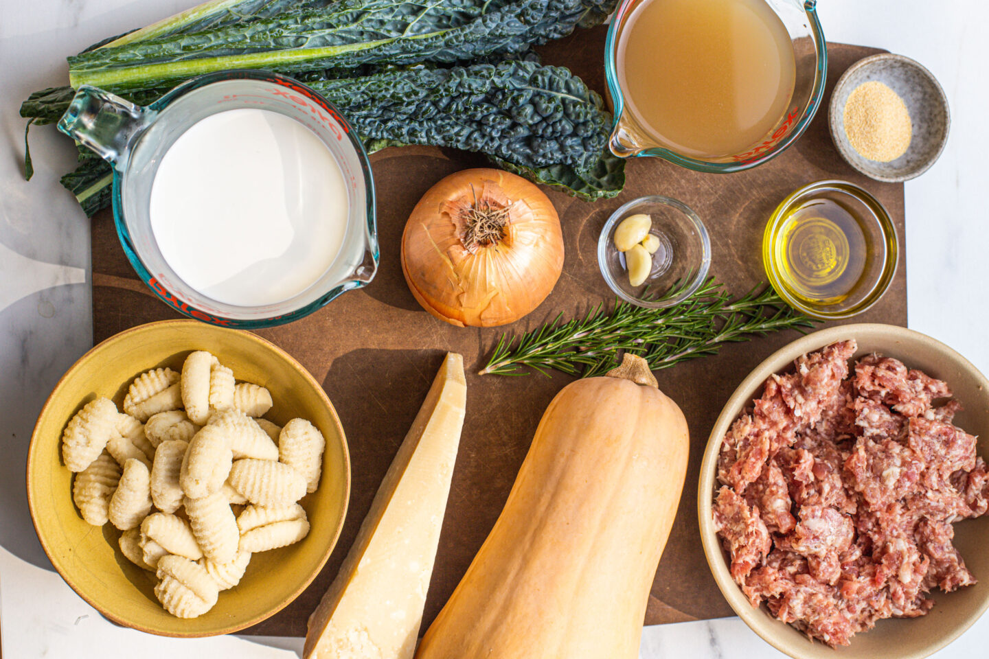 half and half, gnocchi, kale leaves, yellow onion, parmesean cheese, butternut squash, garlic cloves, olive oil, garlic powder, italian sausage