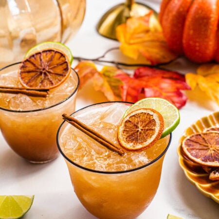 pumpkin spice margarita in a low glass with a black rim