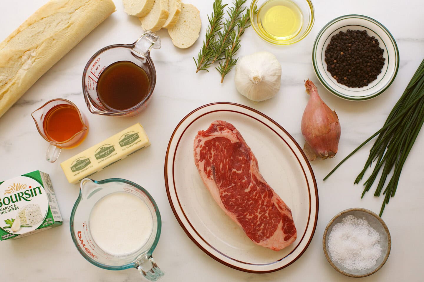 french baguette, beef stock, cognac, boursin cheese, butter, heavy cream, ny strip steak, olive oil, shallot, peppercorns, chives, salt